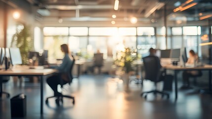 Blurred Office Interior with Sunlit Windows and Workers at Desks
