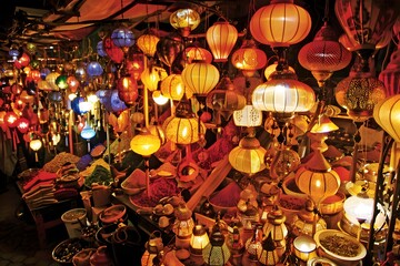 Arabian souk at night with traditional lanterns lighting up the bustling market streets