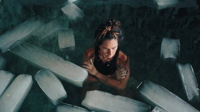 Healthy Woman Diving into Cold Water of Swimming Pool with Ice Cubes for Good Body Health. Strong Person in Bathtub Full of Chilly Aqua for Plunge. Extreme Training of One Healthy Lady Using Icy Bath