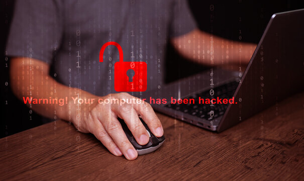 Cybersecurity and safety concept. A padlock is unlocked or hacked with a warning text, while using a notebook computer. Cyber attack, unsecured network, and internet security