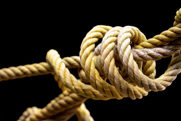 close-up of knotted rope on black background