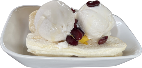 Thai coconut ice cream with nuts and white bread on a plate