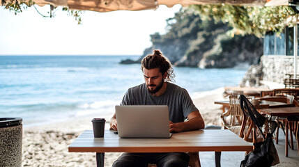 Fototapeta premium A young professional working remotely from a beachside caf with a laptop open and the ocean in the background highlighting the freedom of the digital nomad lifestyle