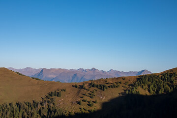 Panoramic view of alpine meadow along hiking trail to Latschur, Gailtal Alps, Austria, Europe. Majestic mountain peaks of Kreuzeck groups in High Tauern. Wanderlust in wilderness of alpine landscape