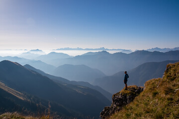 Silhouette of hiker man in alpine landscape of Gailtal Alps, Carinthia, Austria. Panoramic view of...