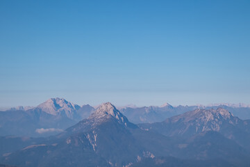 Serene alpine landscape seen from Latschur in Gailtal Alpen, Carinthia, Austria, Europe. Silhouette of majestic hazy mountain ridges of Carnic Alps. Peaceful tranquil atmosphere. Wanderlust. Freedom