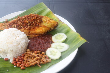 coconut rice with variety side meal such as fish chicken eggs meat and etc Nasi Lemak Berlauk