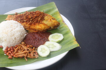 coconut rice with variety side meal such as fish chicken eggs meat and etc Nasi Lemak Berlauk