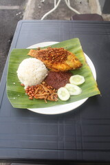 coconut rice with variety side meal such as fish chicken eggs meat and etc Nasi Lemak Berlauk