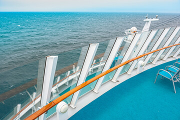 Panoramic view of open deck of cruise ship with blue sea and sky on background