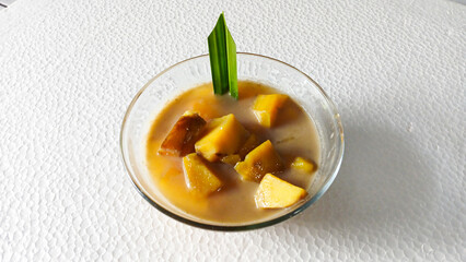Close-Up of sweet potato compote or compote in a clear bowl on a white background. Delicious Desserts during the month of Ramadan. Top view.