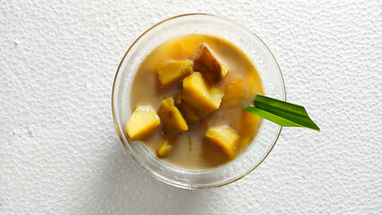 Close-Up of sweet potato compote or compote in a clear bowl on a white background. Delicious Desserts during the month of Ramadan. Top view.