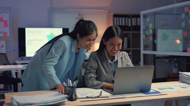 Two enthusiastic businesswomen celebrating a triumph at work, expressing joy and sharing a moment of success in a modern office environment