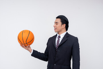 A confident and talented young asian business executive in a full suit. A pro basketball player in formal attire. Zoomed in ball. Isolated on a white background.