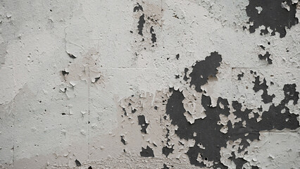 The texture of peeling paint on a concrete wall