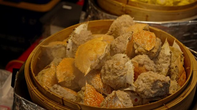 Deep-fried crab meat and minced pork in crab shell (Pu Ja). Chinese Traditional cuisine concept. Dumplings Dim Sum in bamboo steamer. Asian food background.