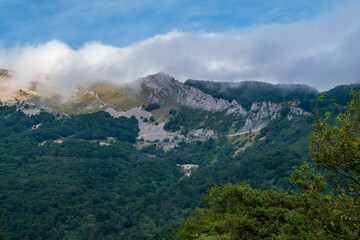beautiful view of mountain tops and white clouds against blue sky in Vercors, pre-Alps region in...