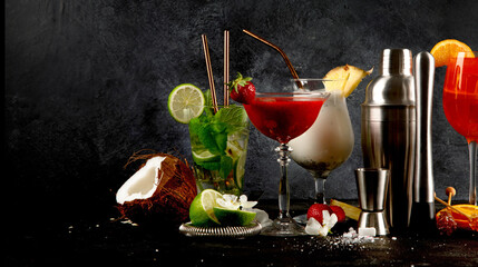 Summer cocktails in classic glasses on a black background. Party time. Tasty drinks