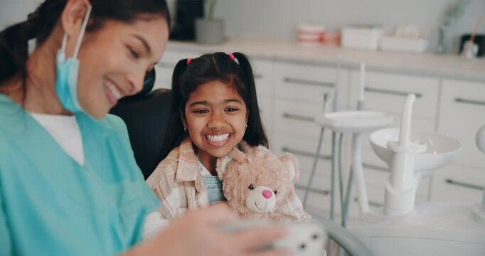Dentist, child or smile in clinic for selfie, support or ready for procedure. Oral care, kid and happy with orthodontist for trust, teddy bear or photography for dental portfolio or social media site