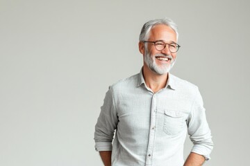 Senior man with grey hair smiling confidently.