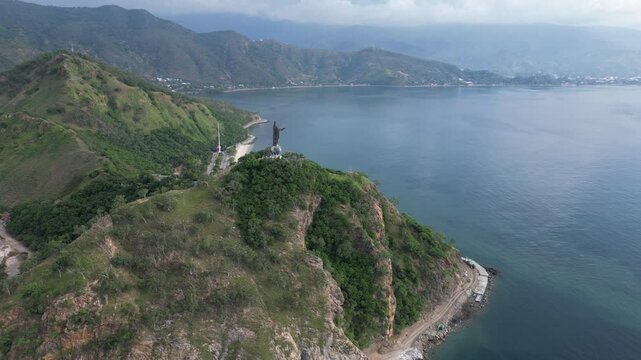 A scenic coastline with lush green hills and calm blue waters near timor leste , aerial view