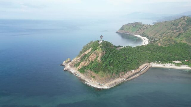 Timor leste coastline with lush green hills and a small cape in the java sea, aerial view