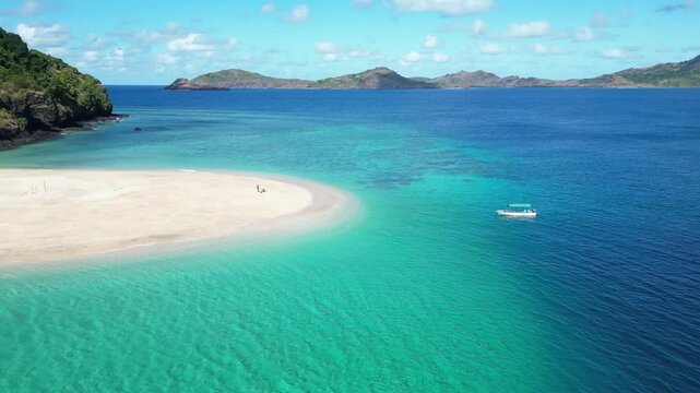 Aerial view of Union of the Comoros, island of Moh&eacute;li in marine National Park, drone fly above solitary dreamy tropical beach with lonely boat moored at bay