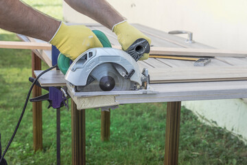 A man is using a power tool to cut a piece of wood