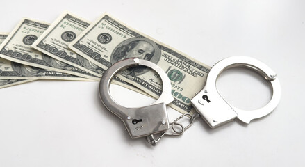 Dollars of hundred and fifty dollars lie on a floor and from above handcuffs for detention of the...