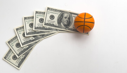 a model of a basketball ball on dollars