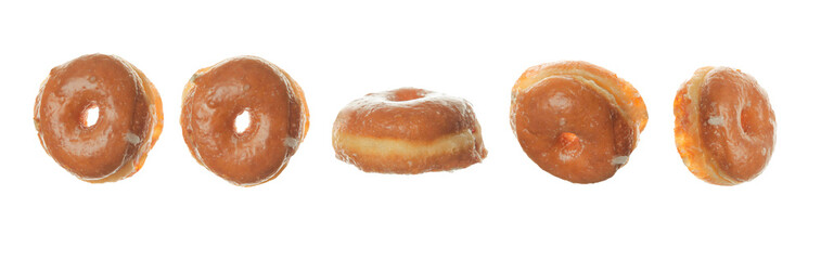 Plain glazed brioche doughnuts in different angles isolated on a white background.