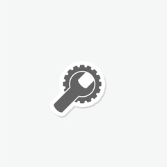 Gear and a wrench icon sticker isolated on gray background