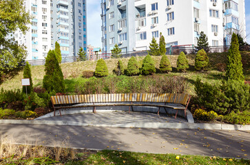 Rest area with bench surrounded by trees in Kyiv, Europe. Place to rest in the city park at autumn