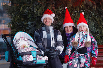 Family in red hats and caps in Christmas decoration