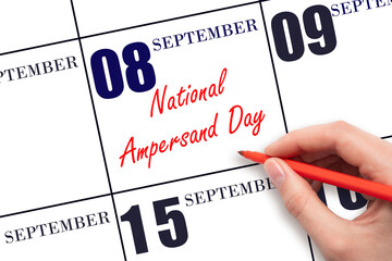 September 8. Hand writing text National Ampersand Day on calendar date. Save the date.