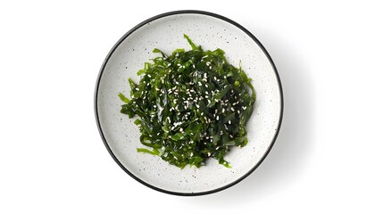Healthy seaweed salad with sesame seeds in speckled ceramic bowl