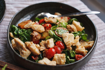 Delicious salad with fried eggplant, tomatoes, herbs and meat. 
