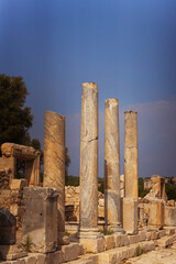 A picturesque row of stone columns set against a bright blue sky