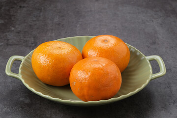Fresh and ripe oranges fruits on plate
