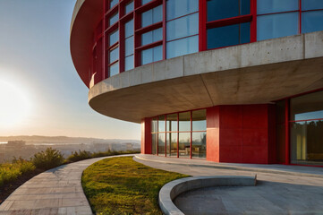 Red concrete renaissance house with curved lines.