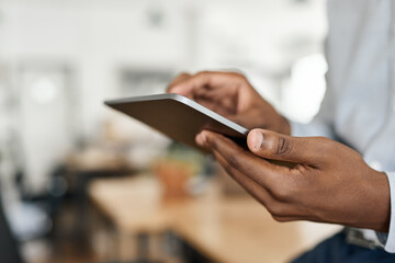 Fototapeta premium Closeup of an African businessman using a digital tablet