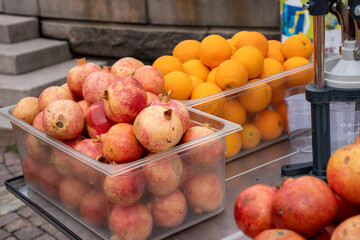 Pile of fresh pomegranates and oranges