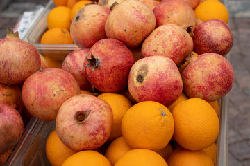 Pile of fresh pomegranates and oranges