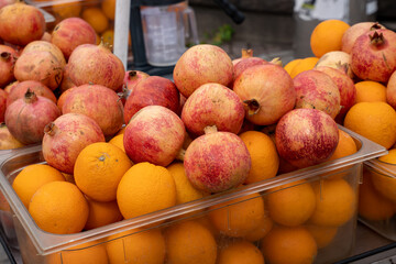 Pile of fresh pomegranates and oranges