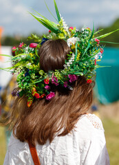 Naklejka premium A wreath of flowers on a girl's head. Back view