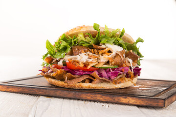 Doner Kebab Doner Kebap fast food snack in flatbread on a wooden table