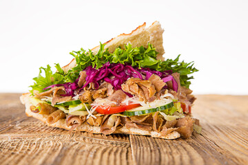 Doner Kebab Doner Kebap fast food snack in flatbread on a wooden table