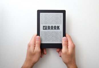 Hands holding an ebook with text on white isolated table