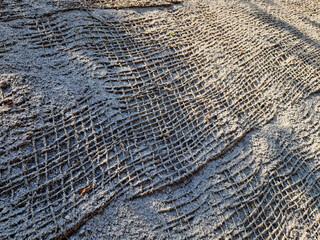 stabilization of slopes by hydro sowing. a mixture of wood pulp and green grass seed is sprayed...