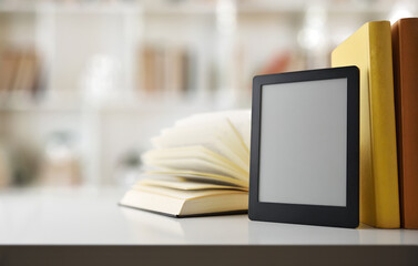 Digital reading concept with ebook on gray bookshelf with traditional paper books and bookshelf...